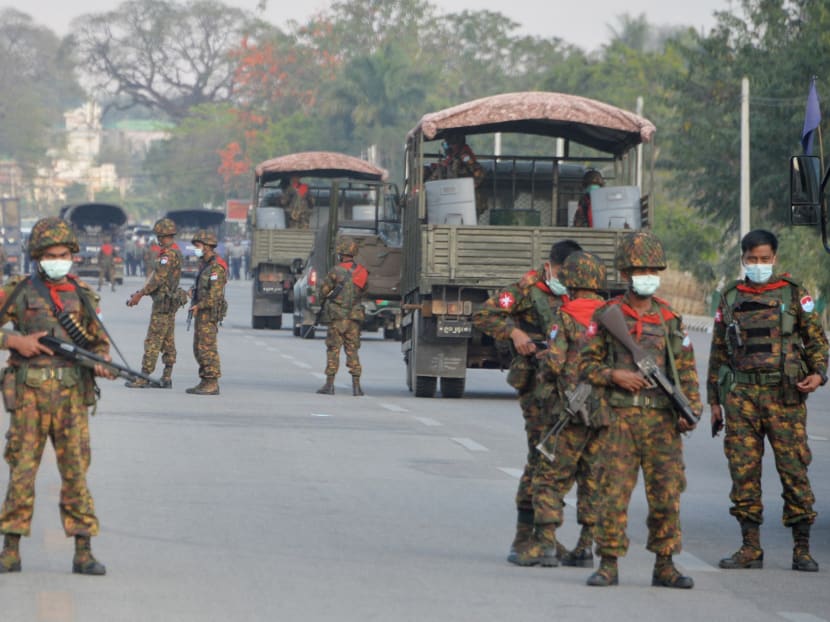 Myanmar soldiers stand guard on a road amid demonstrations against the military coup in Naypyidaw on Feb 17, 2021.