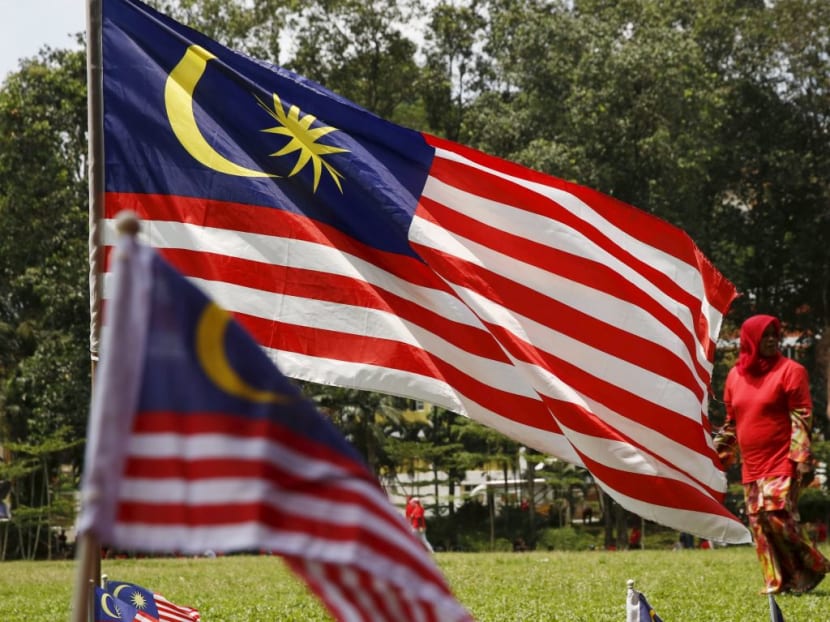 A lady walks past Malaysian flags in Kuala Lumpur. Since the Pakatan Harapan (PH) coalition came to power last month, it has reopened high profile cases believed to have been undermined by deficiencies in the justice process during the Najib administration. A lady walks past Malaysian flags in Kuala Lumpur. Since the Pakatan Harapan (PH) coalition came to power last month, it has reopened high profile cases believed to have been undermined by deficiencies in the justice process during the Najib administration.