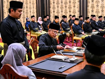 Mr Anwar Ibrahim (seated at far end of desk) at the swearing-in ceremony at the National Palace in Kuala Lumpur on Nov 24, 2022 after he was appointed as Malaysia's new prime minister.