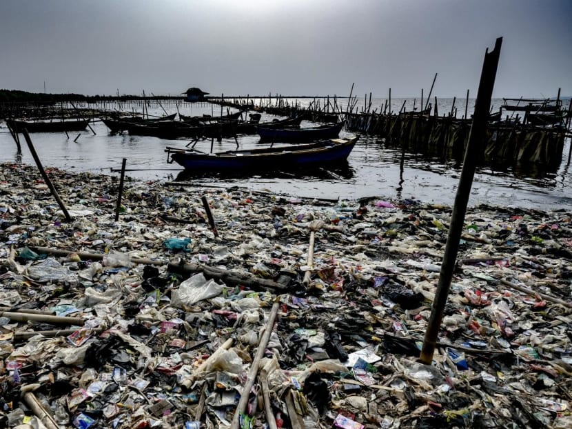 A fisherman preparing his boat for fishing next to a dirty beach filled with plastic waste at Tanjung Pasir beach in Tangerang, Indonesia on July 28, 2023. A fisherman preparing his boat for fishing next to a dirty beach filled with plastic waste at Tanjung Pasir beach in Tangerang, Indonesia on July 28, 2023.