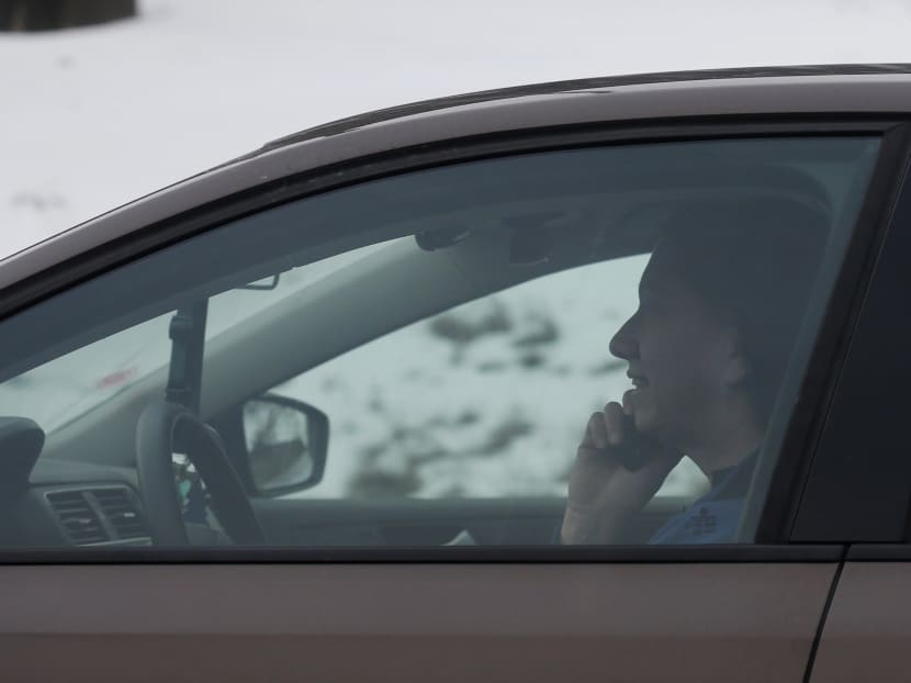 A motorist talks on a cell phone while driving on an expressway in Chicago.  Photo: AP