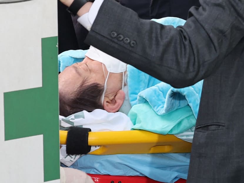 South Korean opposition party leader Lee Jae-myung, who was attacked in Busan, lies on a stretcher as he arrives at Seoul National University Hospital in Seoul on January 2, 2024. South Korean opposition party leader Lee Jae-myung was stabbed in the neck on January 2, by a man who pushed through a crowd pretending to be his supporter. South Korean opposition party leader Lee Jae-myung, who was attacked in Busan, lies on a stretcher as he arrives at Seoul National University Hospital in Seoul on January 2, 2024. South Korean opposition party leader Lee Jae-myung was stabbed in the neck on January 2, by a man who pushed through a crowd pretending to be his supporter.