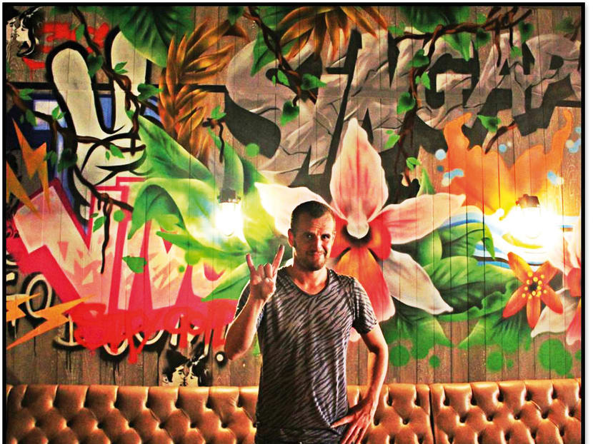 Barnaby Purdy poses with his work at Jamie’s Italian in VivoCity.