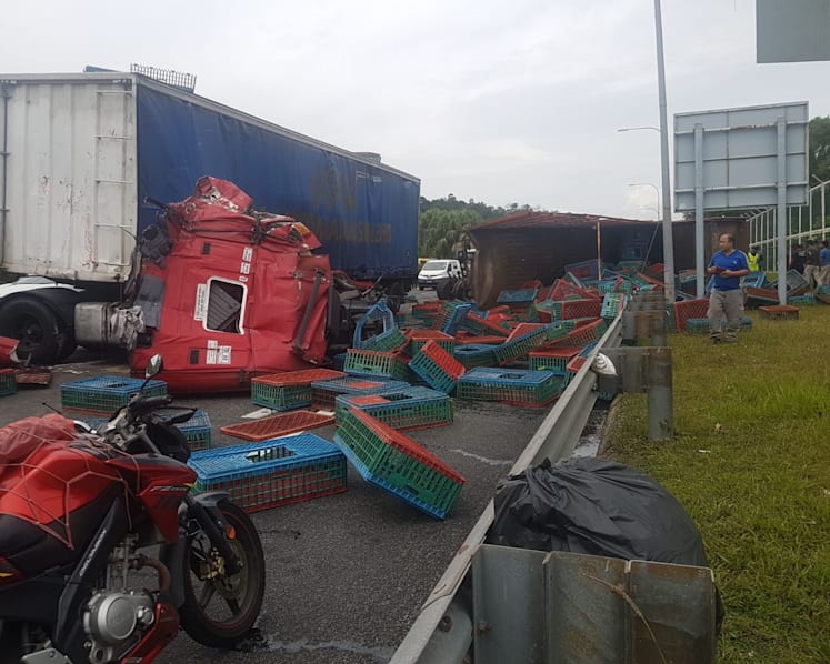 Accident along Tuas Second Link causes lorry to flip over, sends crates flying