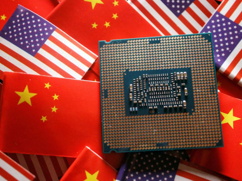 A central processing unit semiconductor chip is displayed among flags of China and the US, in this illustration picture taken Feb 17, 2023.