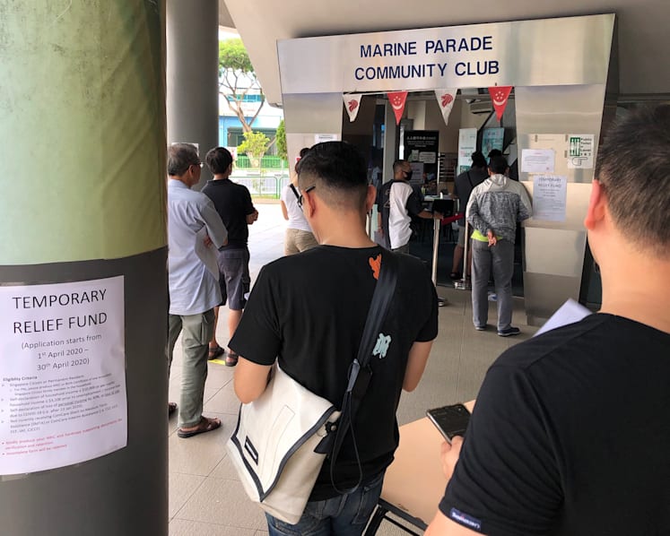 Thousands of people queue to get S$500 financial aid at social service offices and CCs as applications open