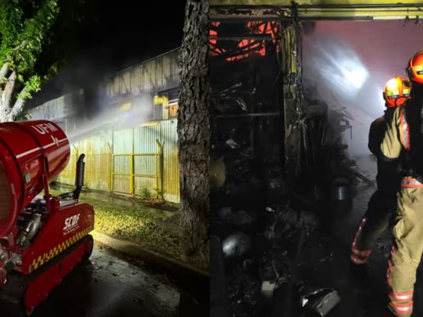 An unmanned firefighting machine and firefighters from the Singapore Civil Defence Force (SCDF) at a fire in Defu Lane industrial estate on April 3, 2024.