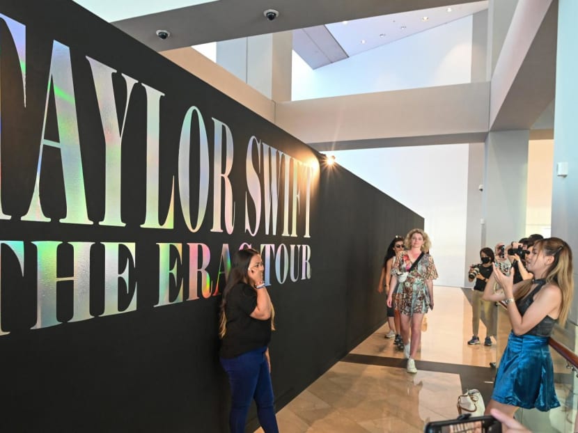 Fans of American singer Taylor Swift taking pictures next to a signage at the "Eras Tour Trail" that depicts different eras of the pop star's career at Marina Bay Sands in Singapore on Feb 28, 2024. Fans of American singer Taylor Swift taking pictures next to a signage at the "Eras Tour Trail" that depicts different eras of the pop star's career at Marina Bay Sands in Singapore on Feb 28, 2024.