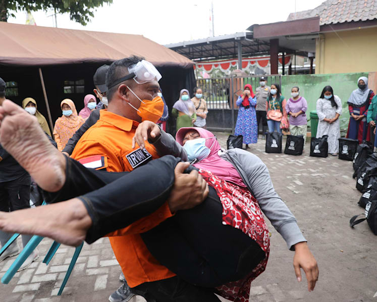 Smouldering debris, mud hinder Indonesia volcano rescue; at least 14 dead