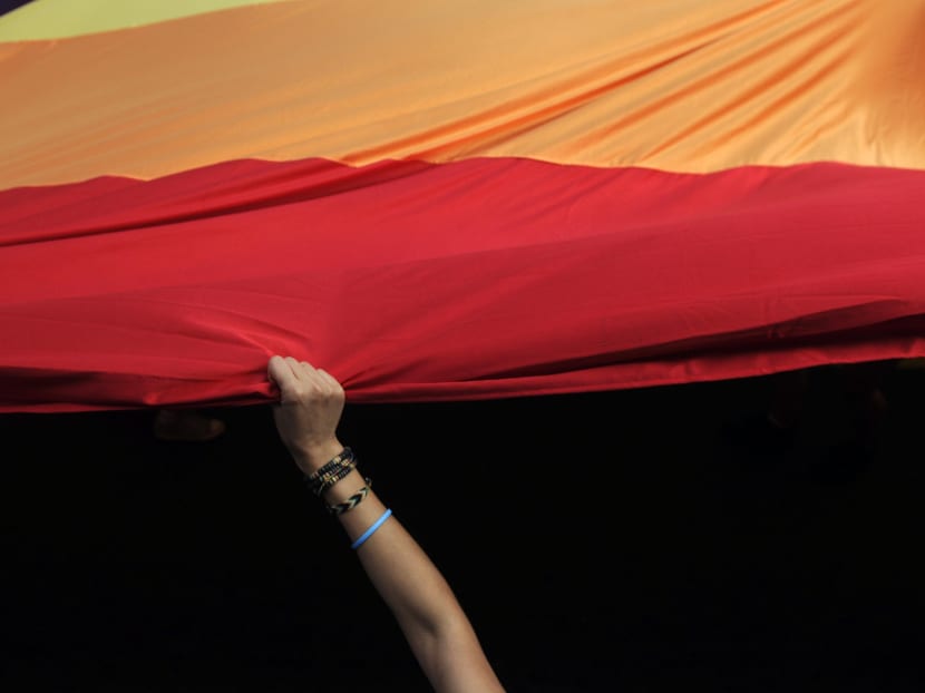A woman holds a huge rainbow flag during the Gay Pride parade in Belgrade on September 18, 2016. Photo: AFP