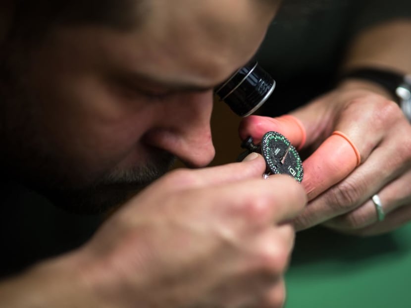 A photo taken on Dec 4, 2023 in Geneva shows ID Geneve watch brand co-founder Cedric Mulhauser working on a watch movement. A photo taken on Dec 4, 2023 in Geneva shows ID Geneve watch brand co-founder Cedric Mulhauser working on a watch movement.