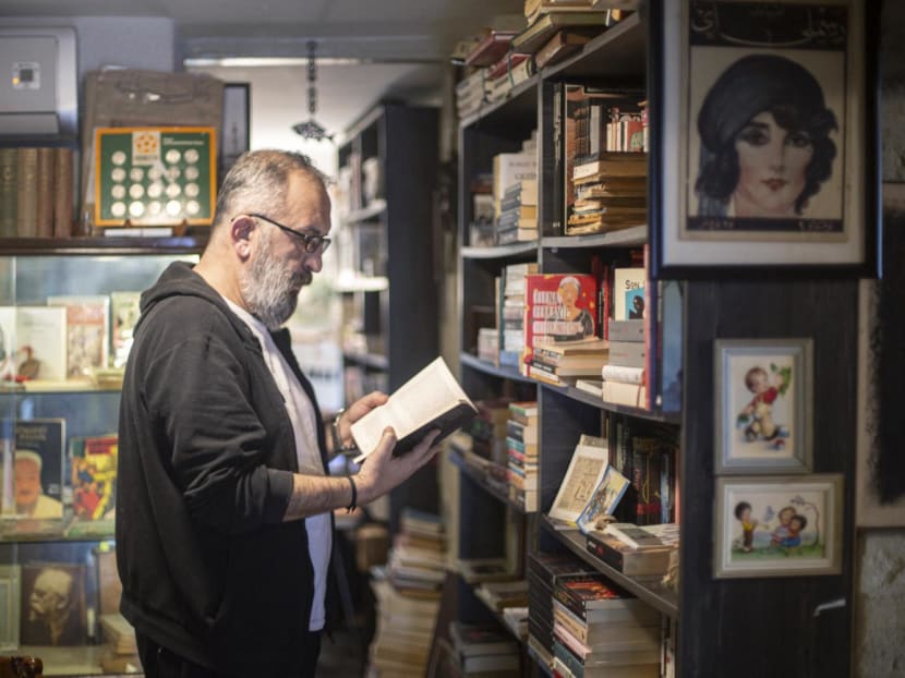 Mr Umit Nar, owner of the Hermes bookshop, reads a book in Izmir, Turkey on Feb 6, 2024. 