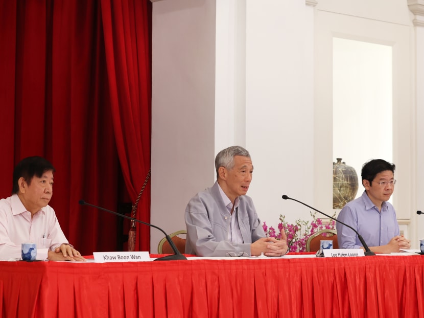 Prime Minister Lee Hsien Loong (centre) held a press conference together with former minister Khaw Boon Wan (left) and Finance Minister Lawrence Wong on April 16, 2022. 