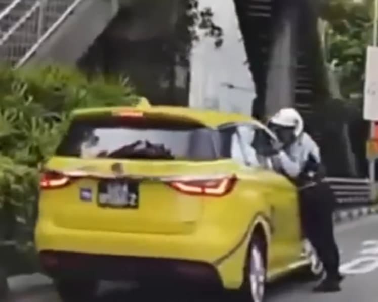 Taxi driver who pinned traffic police officer's arm in window gets jail and driving ban