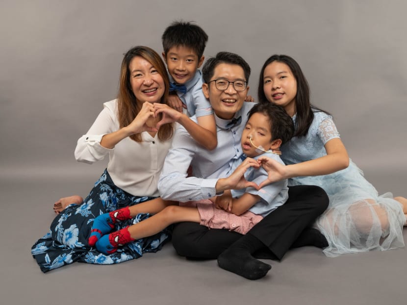 Phua Wenjie, 14, in the arms of his father Phua Wee Seng, surrounded by his mother Yeo Kheng Hui (far left) and his siblings Phua Wenxin (far right), 16, and Phua Wenze (second from left), 10.
Phua Wenjie, 14, in the arms of his father Phua Wee Seng, surrounded by his mother Yeo Kheng Hui (far left) and his siblings Phua Wenxin (far right), 16, and Phua Wenze (second from left), 10.