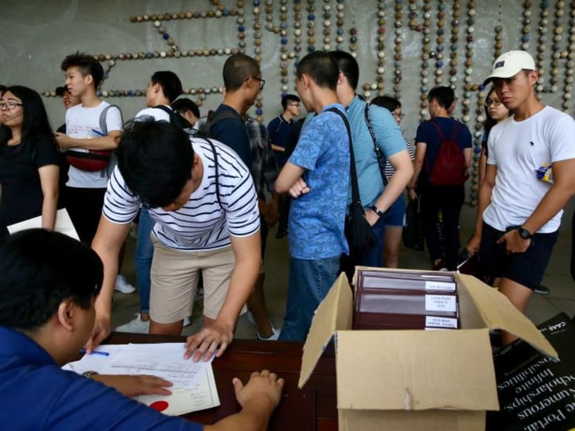 File photo of Nanyang Junior College students receiving their A-Level results.