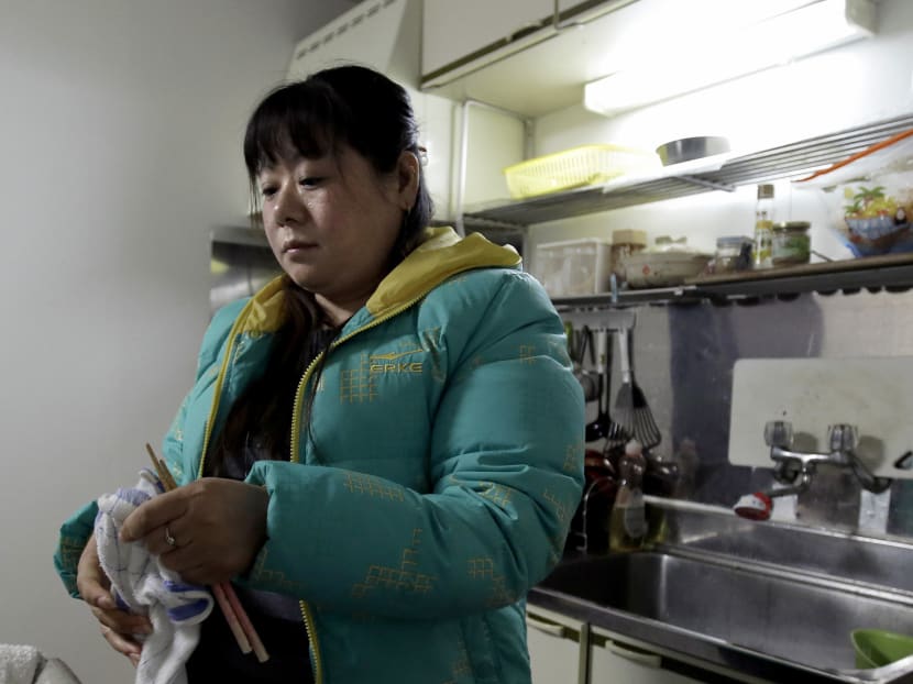 Tang Xili at a shelter for Chinese trainees in Hashima. Photo: Bloomberg