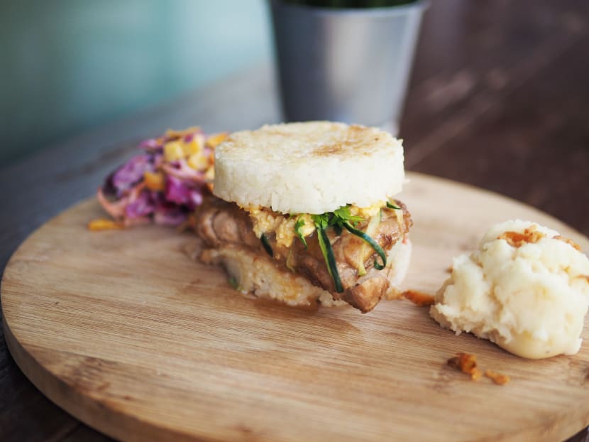 Makcik Chicken's chicken rice burger (S$9.50) consists of two Japanese rice buns, sous vide chicken thigh meat topped off with shredded cucumber and tomato. Photo: Makcik Chicken