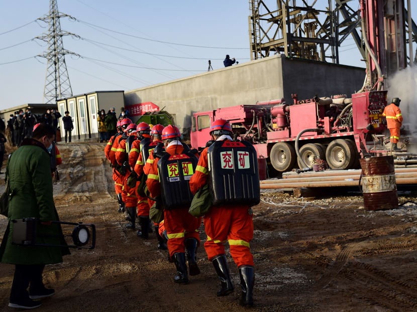 This photo taken on January 13, 2021 shows rescuers working at the site of gold mine explosion where 22 miners were trapped underground in Qixia, in eastern China's Shandong province. Miners trapped underground in eastern China for more than a week after a blast at a gold mine have managed to send up a note to rescuers, the local government said on January 18.