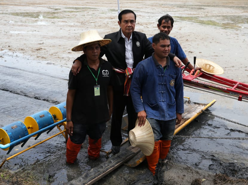 The author says that the return to power of Gen Prayuth, seen here with farmers in Suphanburi province in September, after the next election is far from a done deal.