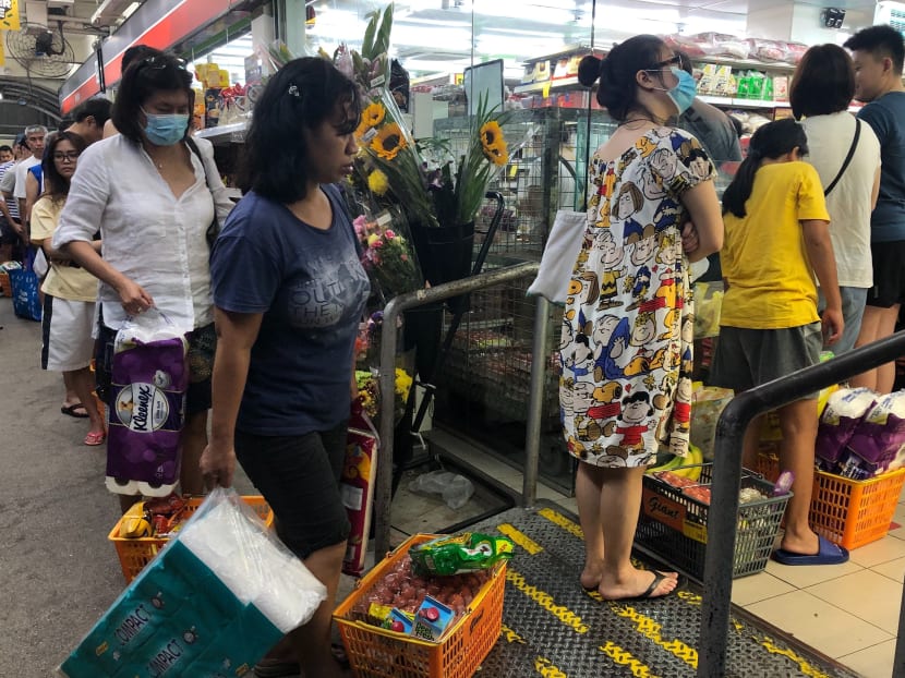 Shoppers queuing up at a Giant supermarket at Marine Terrace on Monday (March 16) night, shortly after Malaysia announced a lock-down.