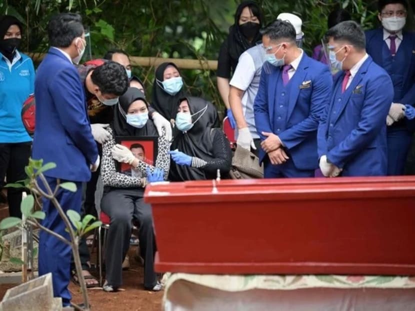 Ms Aldha Refa (seated, centre), the wife of Okky Bisma, a flight attendant and one of the 62 people aboard Sriwijaya Air flight SJ182 which crashed shortly after takeoff on January 9, holds his photo while surrounded by family and friends during his funeral in Jakarta on January 14, 2021. Ms Aldha Refa (seated, centre), the wife of Okky Bisma, a flight attendant and one of the 62 people aboard Sriwijaya Air flight SJ182 which crashed shortly after takeoff on January 9, holds his photo while surrounded by family and friends during his funeral in Jakarta on January 14, 2021.