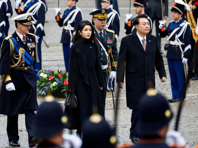 South Korea's President Yoon Suk Yeol and his wife Kim Keon Hee walk during a ceremony in Amsterdam, Netherlands December 12, 2023.