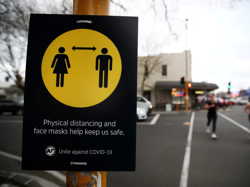 People jog past a social distancing sign on the first day of New Zealand's new coronavirus disease (COVID-19) safety measure that mandates wearing of a mask on public transport, in Auckland, New Zealand, on Aug 31, 2020. People jog past a social distancing sign on the first day of New Zealand's new coronavirus disease (COVID-19) safety measure that mandates wearing of a mask on public transport, in Auckland, New Zealand, on Aug 31, 2020.