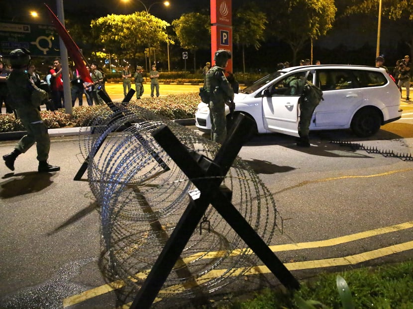 Soldiers from the 3rd Battalion, Singapore Infantry Regiments (3 SIR) check a vehicle in a simulated scenario involving armed perpetrators at a vehicle access control point at the Singapore Sports Hub on Jan 27, 2018. Photo: Nuria Ling/TODAY