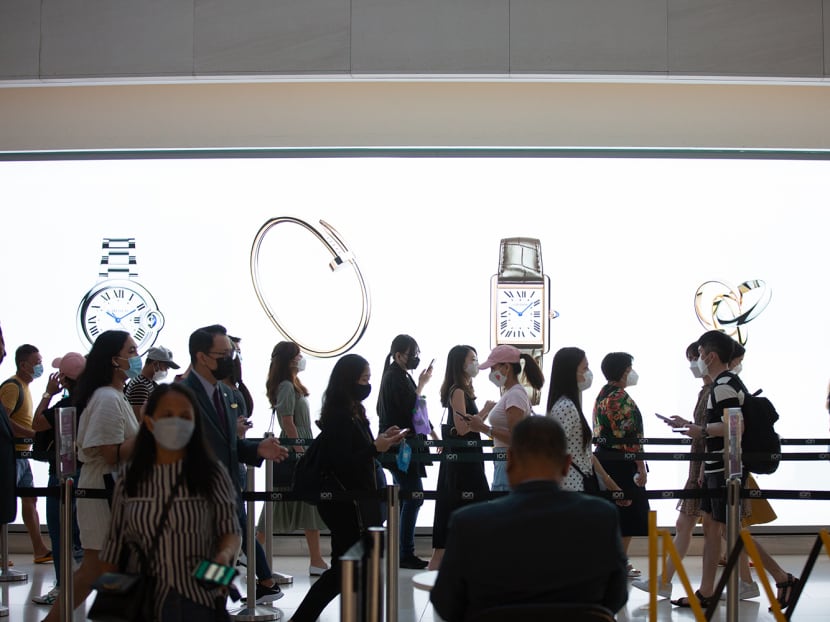 Shoppers at Ion Orchard mall in a file photograph taken in February 2022. Shoppers at Ion Orchard mall in a file photograph taken in February 2022.