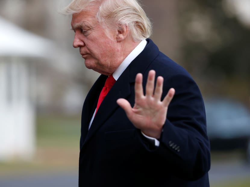 Mr Donald Trump waves as he walks from Marine One upon his return to the White House in Washington on Sunday. Mr Trump’s wiretapping assertions have caused tensions with key US allies. Photo: Reuters