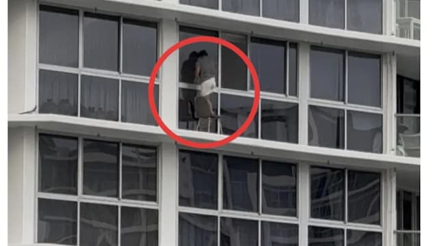 16楼窗外爬椅子上擦玻璃 澳洲女子危险行为引热议