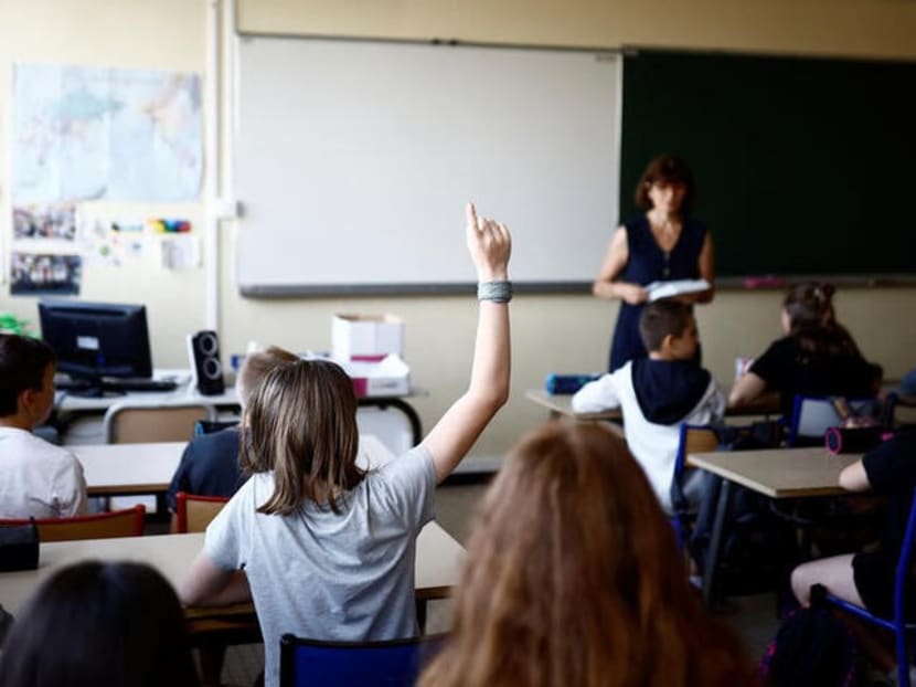 Schoolchildren work in a classroom on the first day of the new school year after summer break in Savenay, France, on Sept 4, 2023.