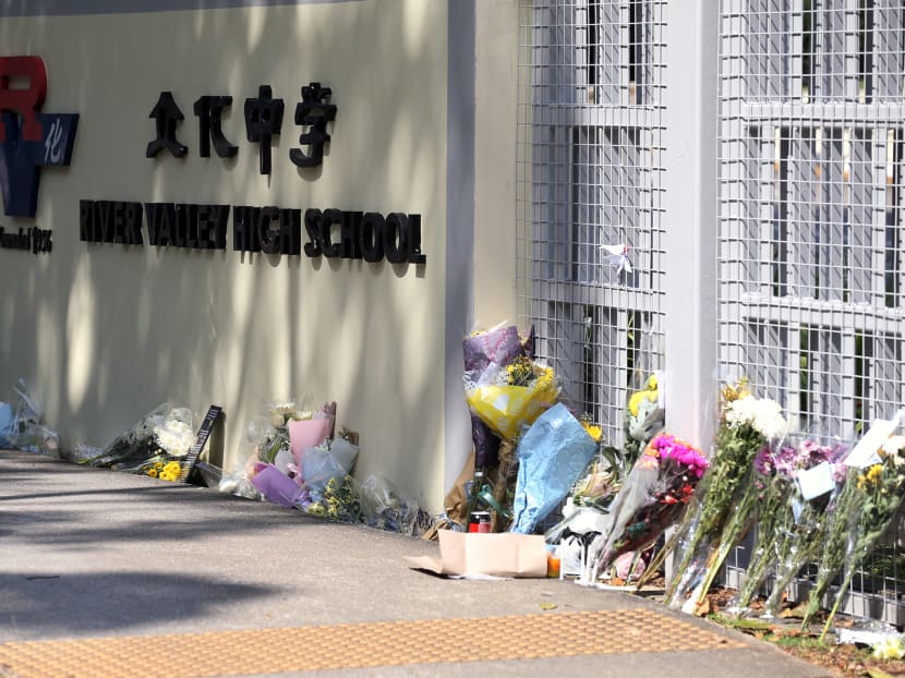 Bouquets of flowers placed at the main gate of River Valley High School on July 25, 2021.
