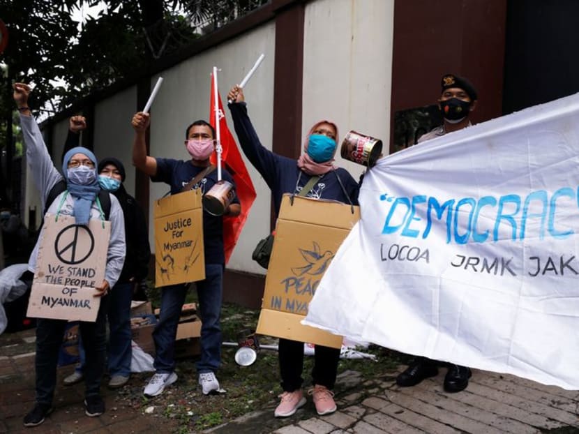 People shout slogans during a protest against the military coup in Myanmar, outside Myanmar's embassy in Jakarta, Indonesia on Feb 5, 2021.