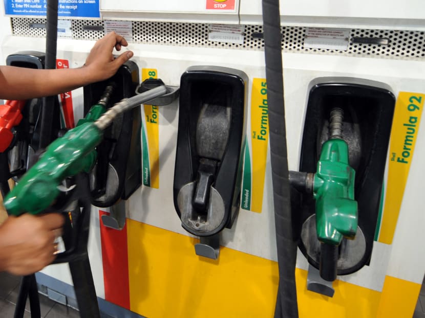 A pump attendant at a petrol kiosk in Singapore. A pump attendant at a petrol kiosk in Singapore.