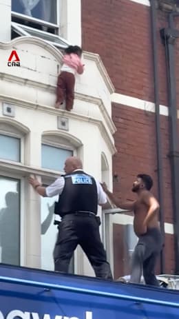 London toddler dangles from window ledge before dramatic rescue
