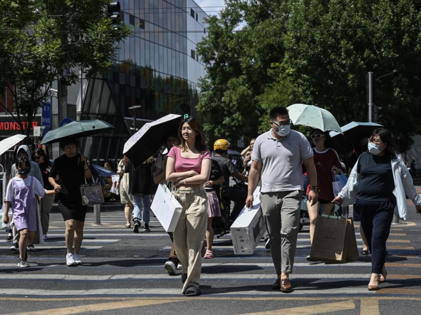 People use umbrellas to shelter from the sun during hot weather conditions in Beijing on July 6, 2023. People use umbrellas to shelter from the sun during hot weather conditions in Beijing on July 6, 2023.