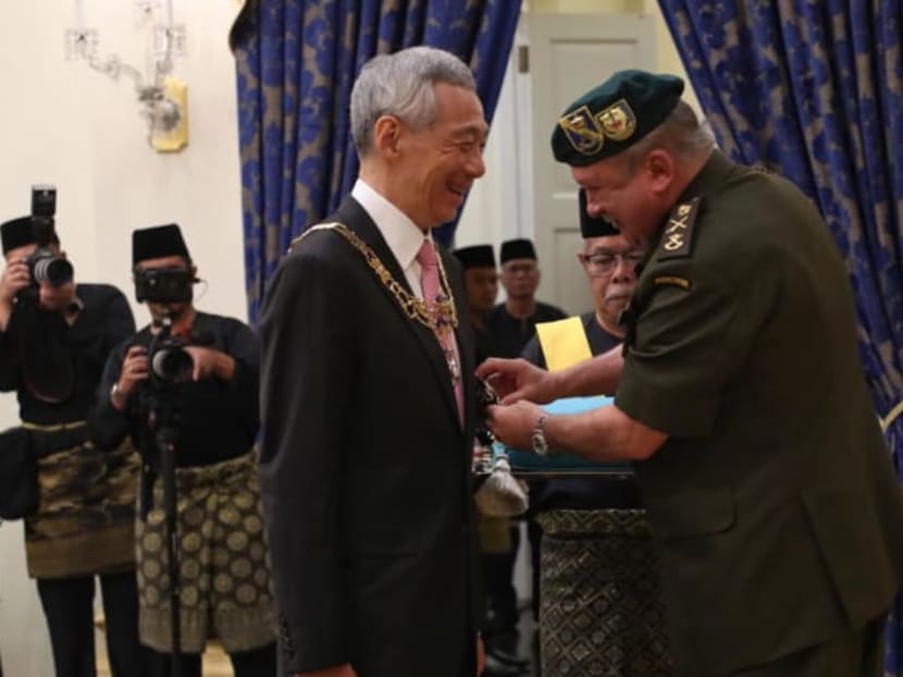 Prime Minister Lee Hsien Loong receiving the award from Sultan Ibrahim Ibni Almarhum Sultan Iskandar at the Johore State Award Investiture Ceremony on May 6, 2022.
