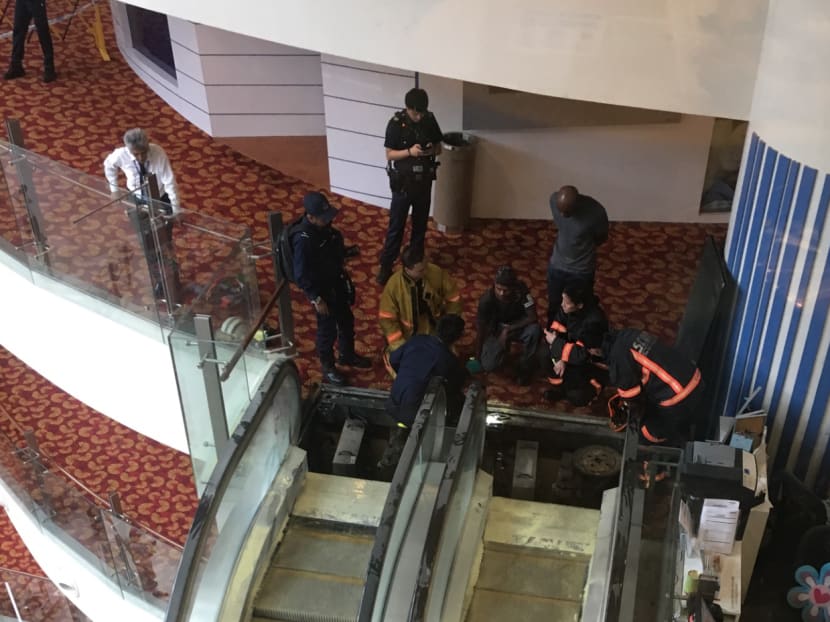 SCDF personnel investigating the cause of the fire at Chinatown Point. Photo: Ooi Boon Keong