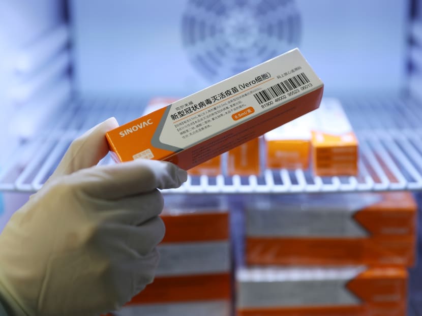 A medical worker taking a box of Sinovac's vaccine from a refrigerator at a community health centre in Qingdao, China on Jan 5, 2021. A medical worker taking a box of Sinovac's vaccine from a refrigerator at a community health centre in Qingdao, China on Jan 5, 2021.