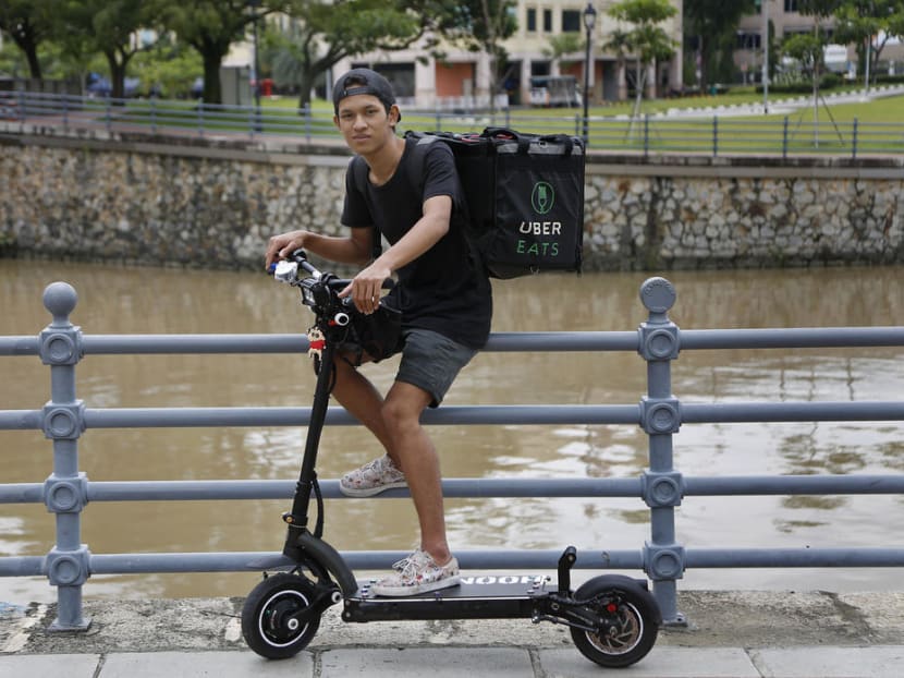 Muhammad Azrul, 18, uses a PMD to do food deliveries. He quit his job as a cleaner as he found delivering food easier while still making the same amount of money. Photo: Raj Nadarajan/TODAY