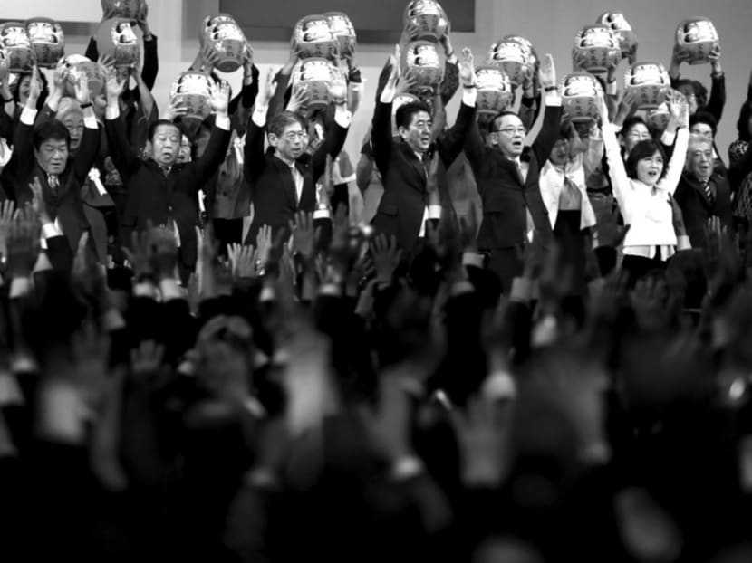 Japanese Prime Minister Shinzo Abe (centre) with members of the ruling LDP Party holding Daruma dolls, which are believed to bring good luck, during the party’s convention in March. Mr Abe’s shrewd power-play has allowed him to neutralise challenges from his rivals and counterbalance factions against one another. Photo: Reuters