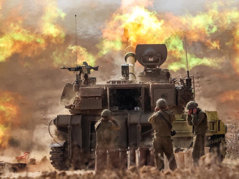 An Israeli army self-propelled howitzer fires rounds near the border with Gaza in southern Israel on October 11, 2023.