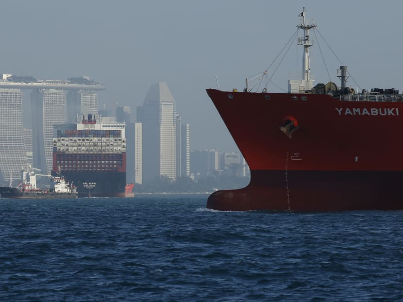 Vessels ply the waters near the Marina Bay Sands hotel along the southern coast of the city in the Straits of Singapore, on Feb 26, 2016.