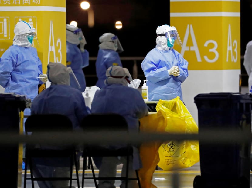 Health workers in protective suits waiting to conduct Covid-19 tests on staff at Pudong Airport in Shanghai, China on Nov 22, 2020.