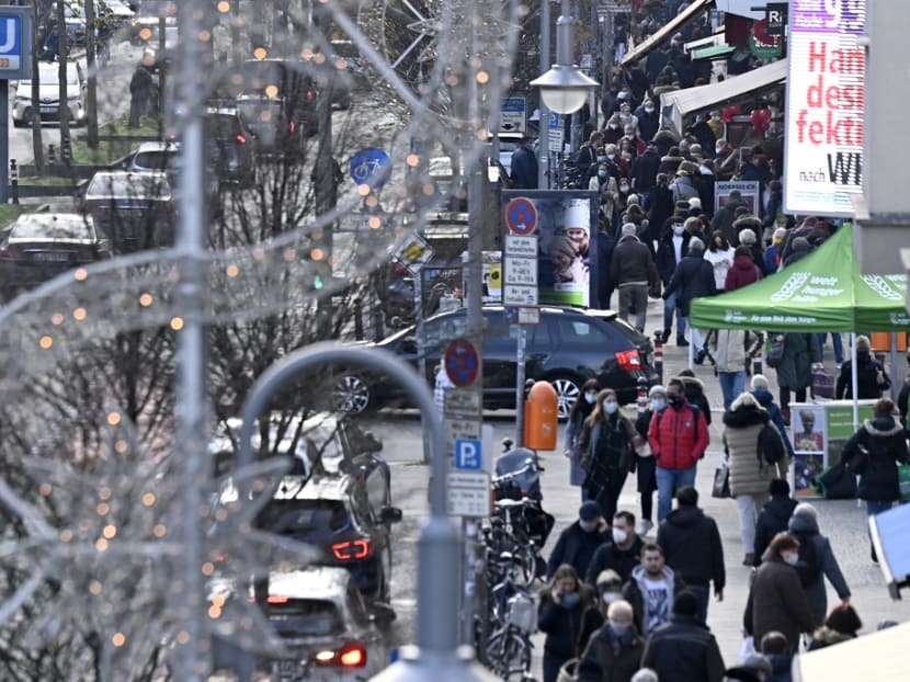 People walk along a shopping street in Berlin's Steglitz district on Dec 14, 2020, a few days ahead of a partial lockdown to halt the spread of the ongoing novel coronavirus pandemic.