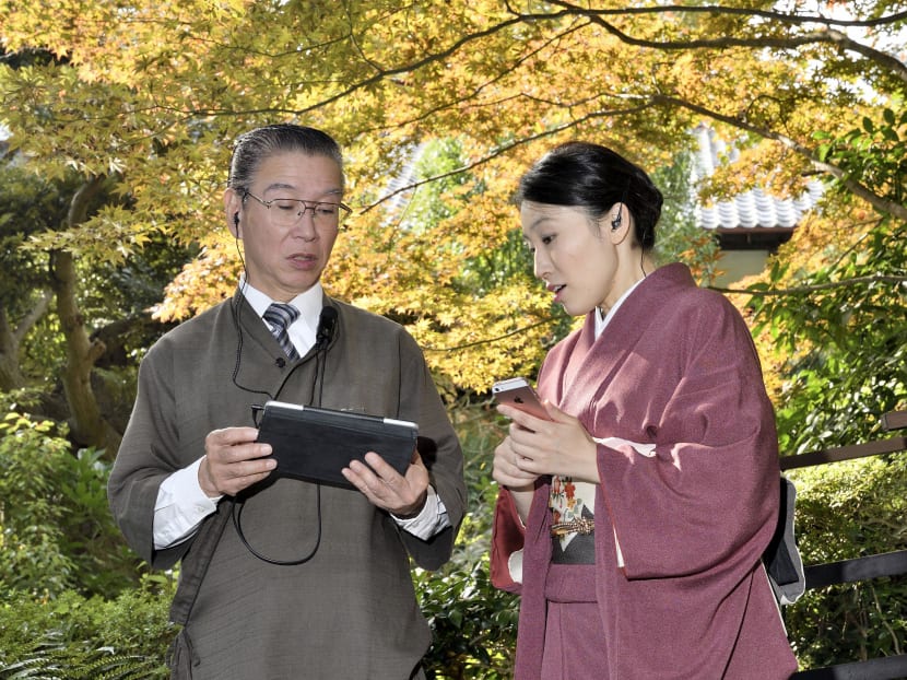 Employees at Jinya, a Japanese-style inn in Hadano, Kanagawa Prefecture, near Tokyo, use a tablet to manage their inn on Nov. 10, 2017. Photo: Kyodo