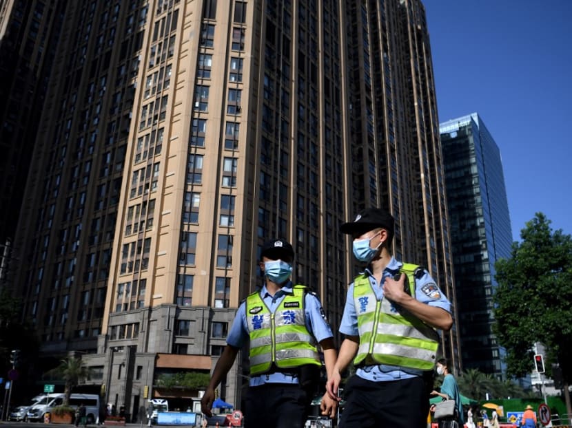 Policemen walk along a road leading to the US Consulate in Chengdu, southwestern China's Sichuan province on July 27, 2020.