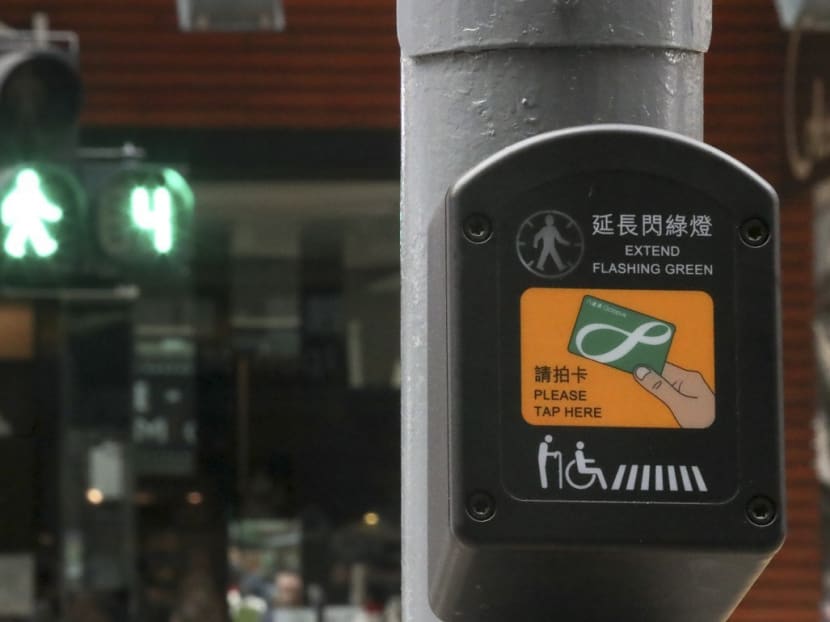 With a single tap of a card, elderly pedestrians and those with disabilities can now get a few extra seconds to make their way across Hong Kong’s busy roads thanks to a device similar to Singapore's smart card reader system. Photo: South China Morning Post